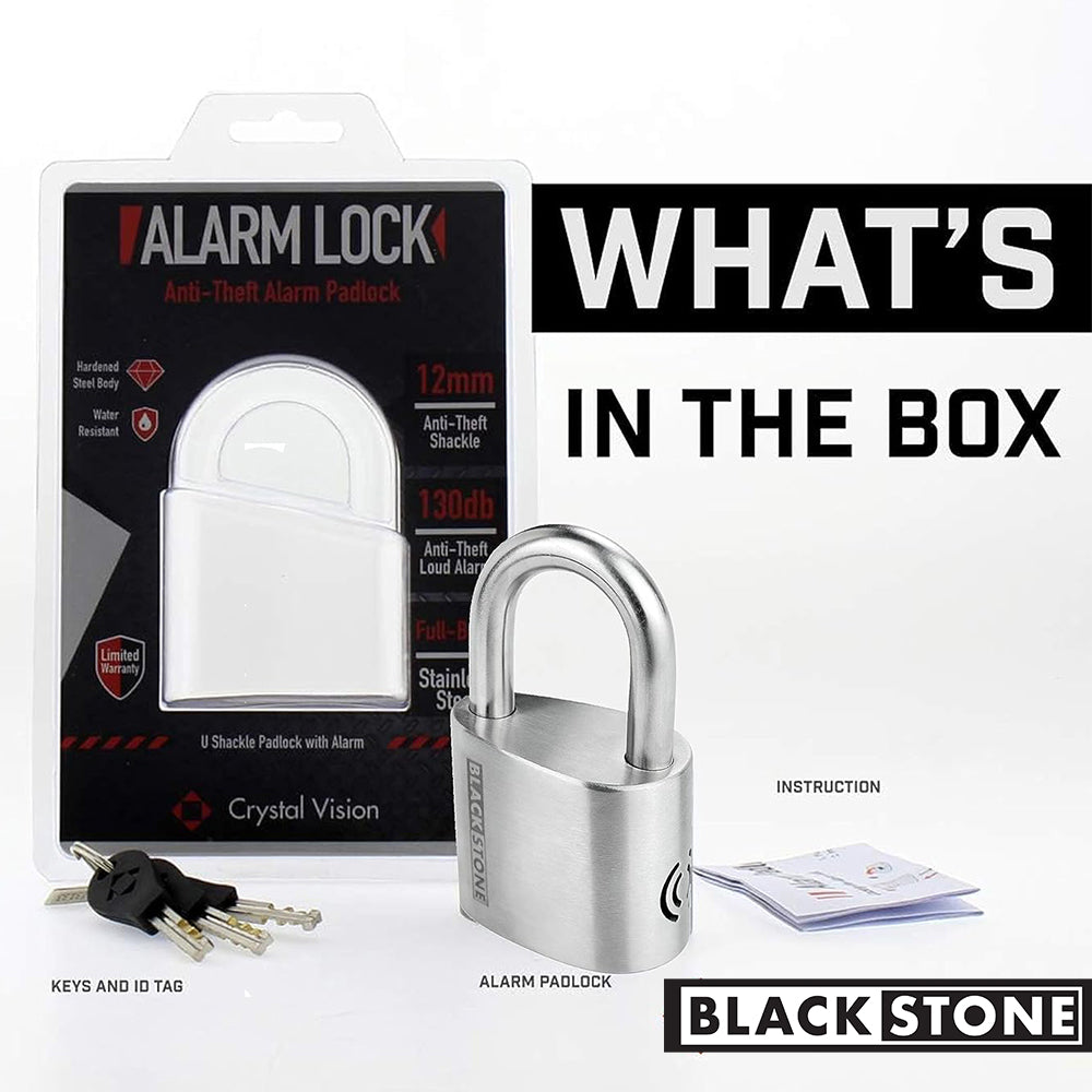 Contents of Black Stone Alarm Lock package displayed with the text 'WHAT'S IN THE BOX', showing a stainless steel padlock, keys with ID tag, and instruction manual
