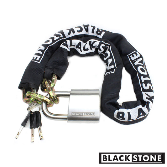 Black Stone heavy-duty chain lock covered with a black fabric sleeve printed with the white brand logo, linked to a silver padlock with keys, on a white background