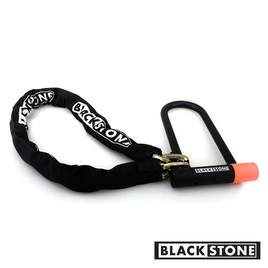 Black Stone branded U-lock with a keyhole covered in a protective pink rubber cap. The lock is attached to a heavy-duty chain with a black sleeve that has the Black Stone logo printed in white letters. Designed for securing bikes or other valuables