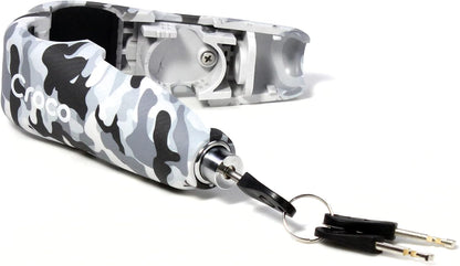The image presents a Camo white Croco bike lock with an inserted key, partially revealing its internal mechanism. The lock is textured to resemble carbon fiber, and the Croco branding is prominently displayed. It seems to be a bar lock, commonly used for bicycles, which implies a lightweight yet secure design. The photo emphasizes the lock's use-case scenario and gives a good impression of how it operates with the key in place