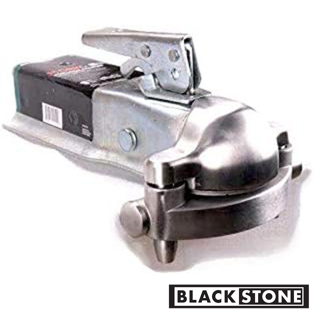 A close-up of a Black Stone branded trailer hitch lock. The metallic lock is attached to a trailer's hitch, ensuring security. The image has a slight blur, emphasizing the lock as the central point of focus, and the brand logo is prominently displayed