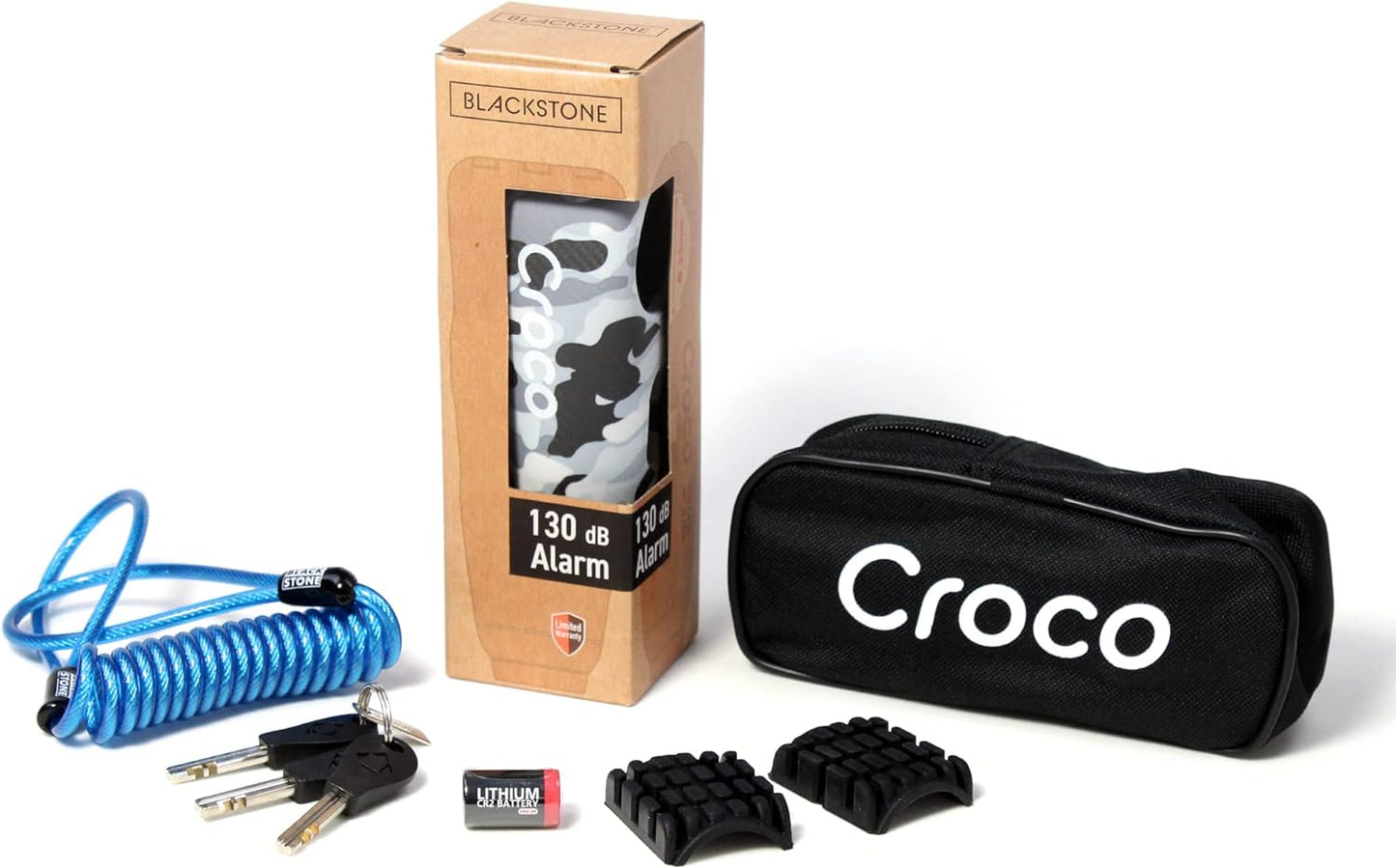 The image shows a product set which includes a Blackstone Croco alarm lock in its packaging, a Blue coiled cable, a black carrying pouch with the text "Croco" on it, three keys, a battery, and Two rubber pads for the lock, offering customization for various handlebar thicknesses or preferences. The items are neatly displayed, presumably for marketing or sales purposes