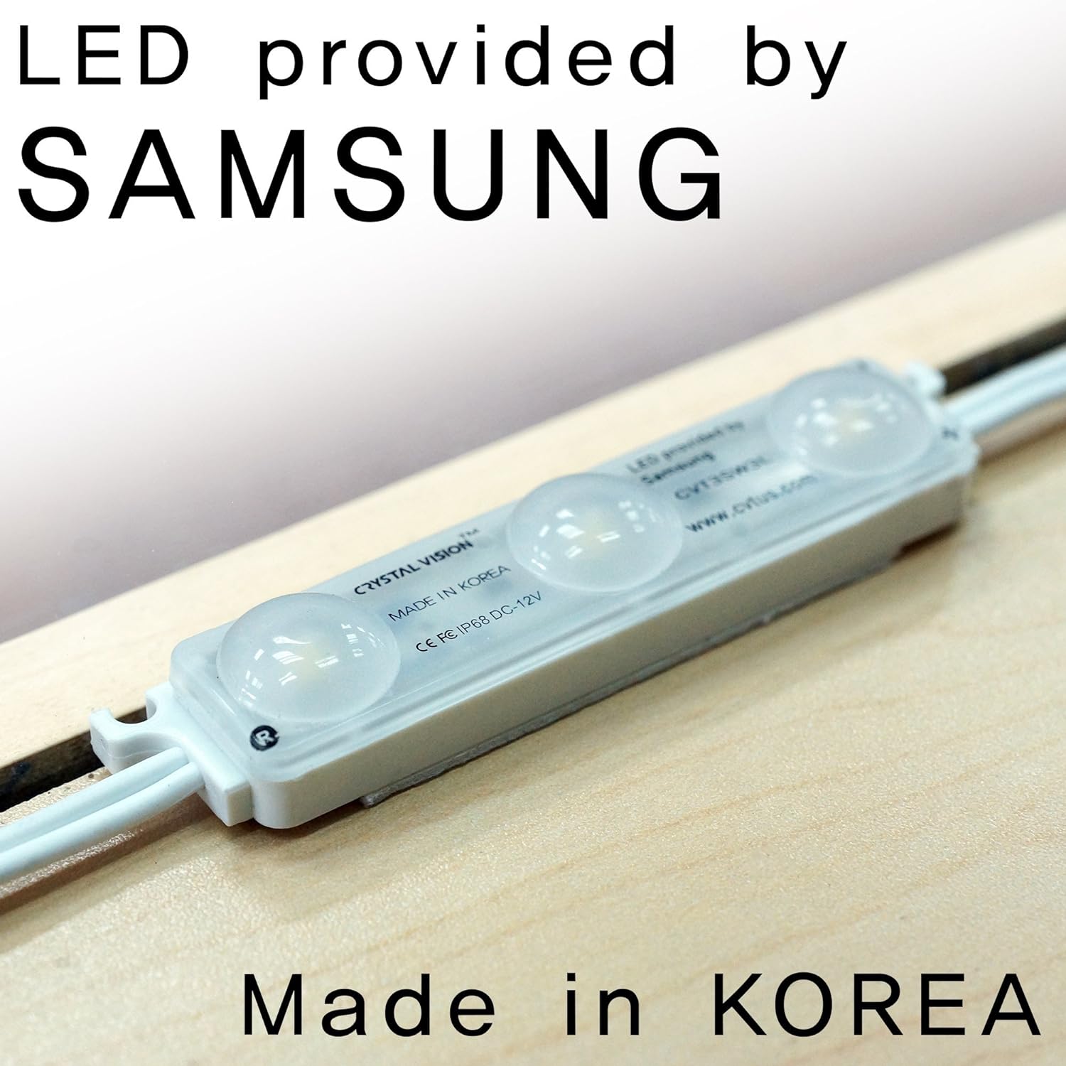 Close-up image of a Crystal Vision LED module with three illuminated lights installed in showcase, marked _LED provided by Samsung_, _Made in Korea_, and the company_s website address